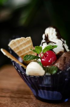 gourmet organic chocolate and strawberry ice cream sundae dessert with cherry and banana
