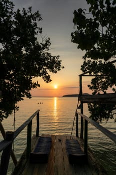 view from rustic wood sun deck on Koh Ta Kiev island near Sihanoukville  in Cambodia at sunset