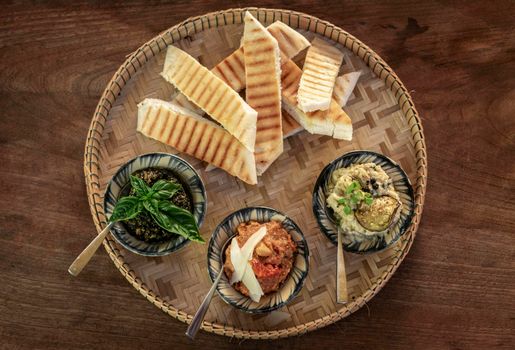 vegetarian turkish mezze snack tapas platter on rustic wood restaurant table