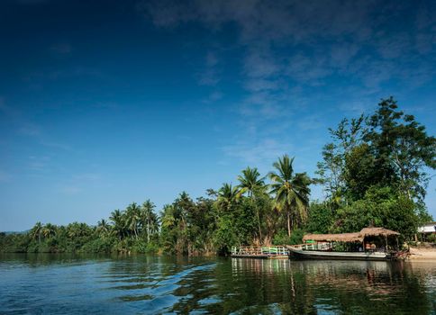 traditional jungle ferry boat at pier on tatai river in cambodia