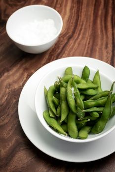 organic edamame beans snack in bowl on table with sea salt