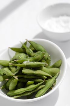 organic edamame beans snack in bowl on table with sea salt