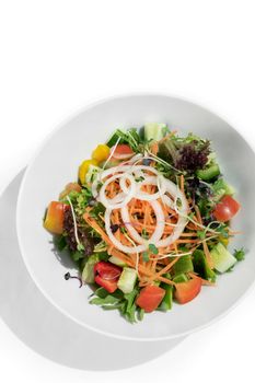 fresh organic mixed vegetable vegan Garden Salad with Vinaigrette sauce on white table