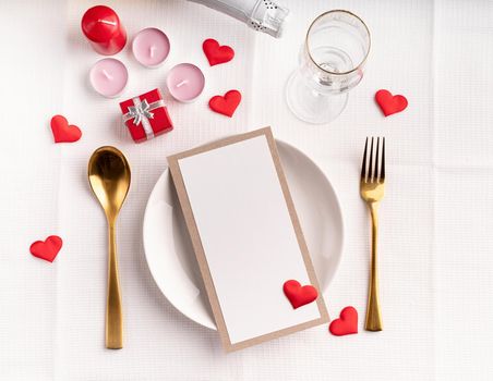 Valentines day table setting with menu, plate, bottle of champagne top view, mock up design