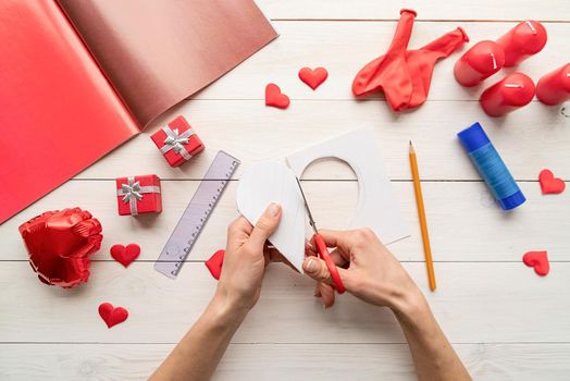 Valentines Day craft DIY. Step by step instruction making paper heart shape hot air balloon. Step 2 - cut out the heart