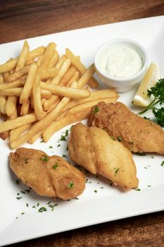 british traditional fish and chips meal on wood table