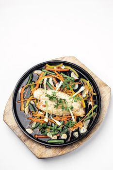 chinese cantonese style steamed spicy fish fillet with vegetables on hot plate