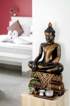 bronze buddha statue interior design detail in modern asian home living room