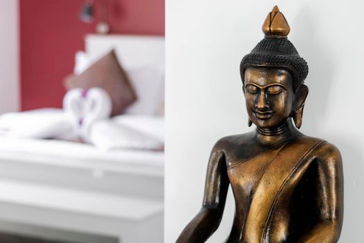 bronze buddha statue interior design detail in modern asian home living room