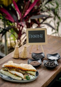 vegan roasted vegetable toasted panini sandwich in rustic garden table setting outdoors in sicily