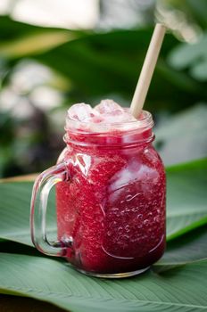 beetroot and carrot healthy organic vegetable smoothie outdoors in glass jar