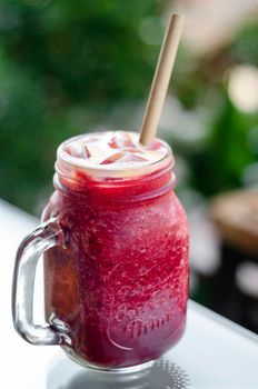 beetroot and carrot healthy organic vegetable smoothie outdoors in glass jar