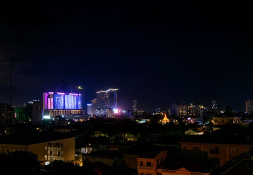 downtown central phnom penh city night view in cambodia with Naga World casino complex and Koh Pich Diamond Island skyline