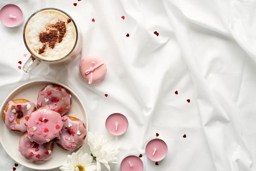 valentines day concept. Small donuts on white bed with cup of coffe