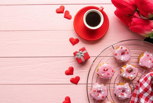 valentines day concept. Valentines day brackfast with coffe and donuts isolated on pink wooden background