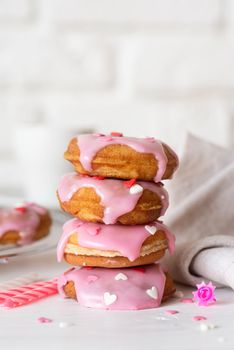Valentine's Day concept. Pink glaze donuts with hearts