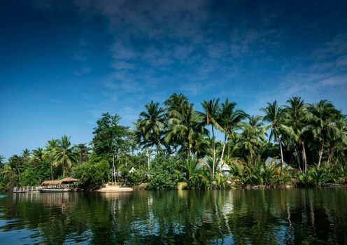 traditional jungle ferry boat at pier on tatai river in cambodia