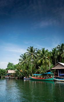 traditional jungle ferry boat at pier on tatai river in cambodia