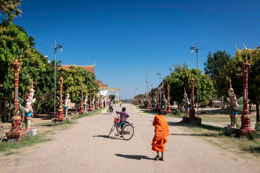 buddhist monk street scene walking outside Wat Svay Andet Pagoda UNESCO site in Kandal Province Cambodia