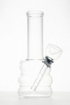 clear glass water bong pipe for smoking medical marijuana or cannabis in white studio background