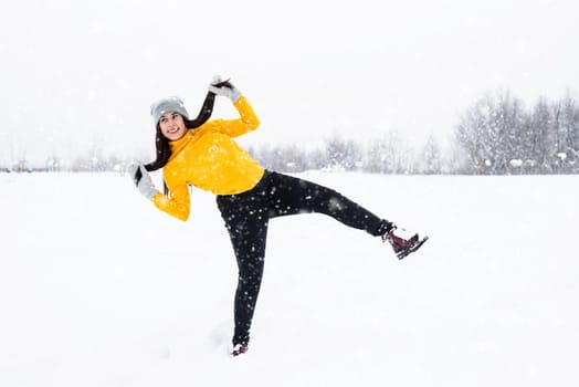 Outdoor concept. Young brunette woman playing with snow in park