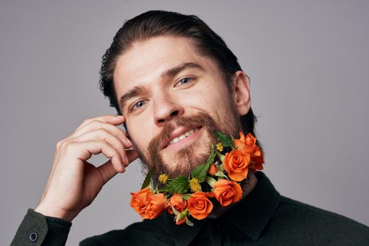 handsome man flowers in a beard black jacket elegant style romance. High quality photo