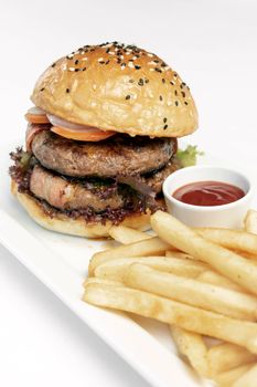 australian organic beef burger with french fries platter on white studio background