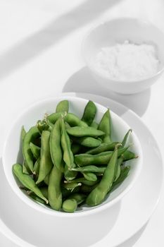 organic edamame beans snack in bowl on table with sea salt