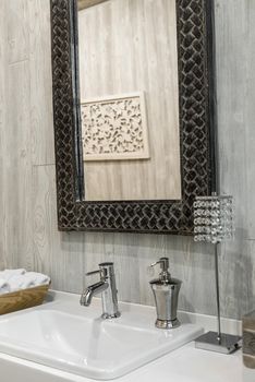 Close-up of a washbasin with a faucet in the bathroom