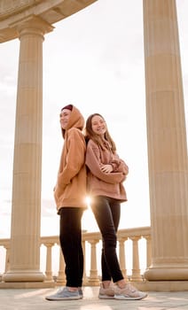 Young hipster couple or friends standing together outdoors in the park