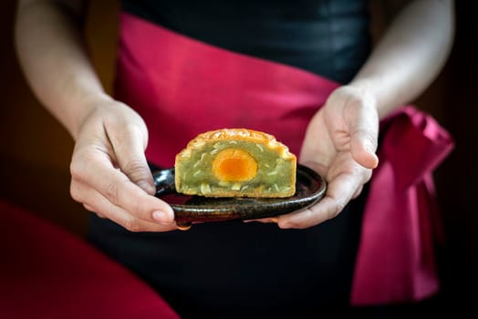 waitress serving traditional chinese gourmet mooncakes festive sweet food closeup