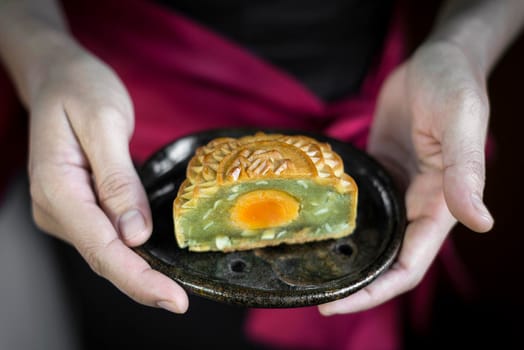 waitress serving traditional chinese gourmet mooncakes festive sweet food closeup