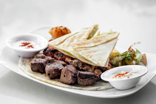 lebanese meshwi mixed bbq grilled meat set with chicken, lamb and beef in beirut restaurant