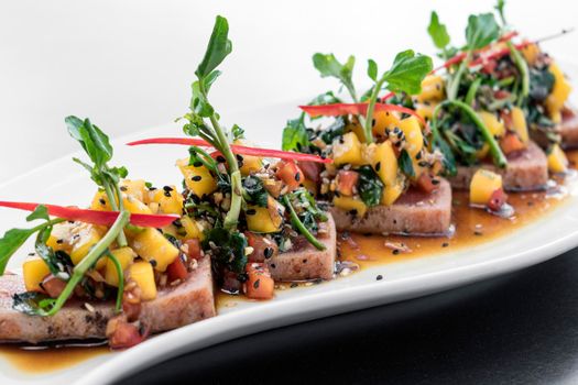 braised tuna and spicy sweet soy mango modern asian fusion gourmet salad in singapore restaurant