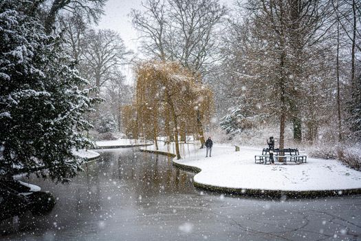 Copenhagen, Denmark - January 06, 2021: People enjoying a snowy winter day in Frederiksberg Gardens.