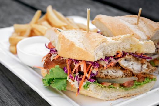 fried battered fresh fish fillet sandwich with coleslaw salad french fries and tartar sauce