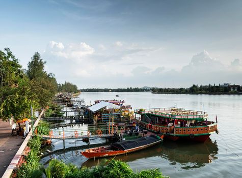 tourist restaurant boats and landscape at riverside in central kampot town cambodia