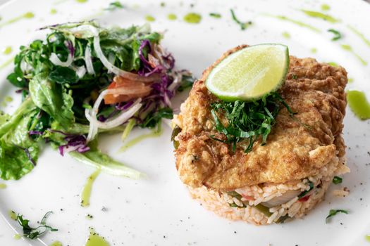 fresh fried battered cod fish fillet summer light lunch meal with basque mixed vegetable spicy rice and salad