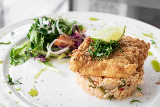 fresh fried battered cod fish fillet summer light lunch meal with basque mixed vegetable spicy rice and salad