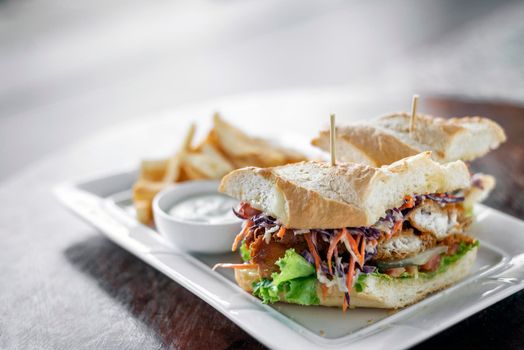 fried battered fresh fish fillet sandwich with coleslaw salad french fries and tartar sauce