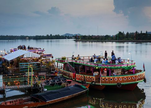 tourist restaurant boats at sunset river side in central kampot town cambodia