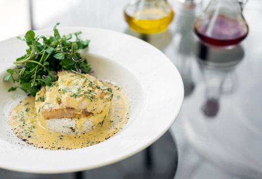 sea bream fish fillet in creamy mustard dill and lemon sauce restaurant meal on plate