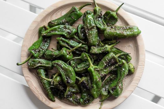 pimientos padron grilled spanish green chilli peppers tapas snack on plate in rustic santiago de compostela restaurant