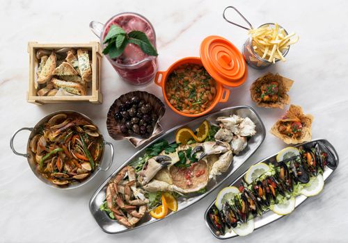 mixed fresh portuguese gourmet seafood selection set on white table in lisbon restaurant