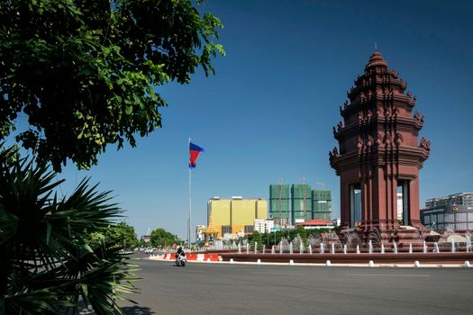 independence monument landmark on central downtown phnom penh city street in cambodia on sunny day