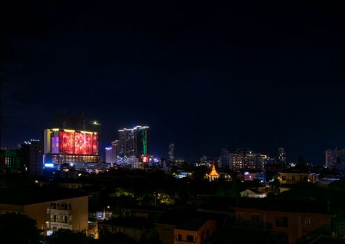 downtown central phnom penh city night view in cambodia with Naga World casino complex and Koh Pich Diamond Island skyline