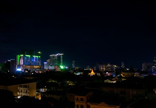 downtown central phnom penh city night view in cambodia with Naga World casino complex and Koh Pich Diamond Island skyline