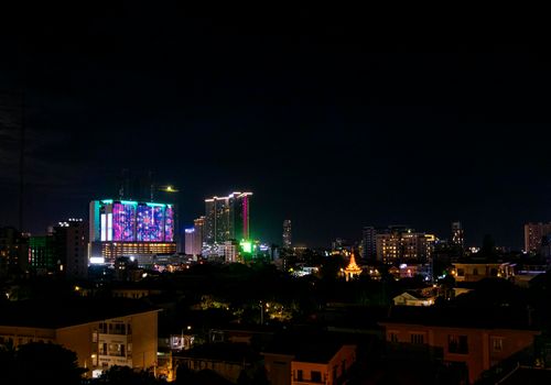 downtown central phnom penh city night view in cambodia with Naga World casino complex and Koh Pich Diamond Island skyline