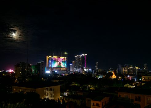 downtown central phnom penh city night view in cambodia with Naga World casino complex and Koh Pich Diamond Island skyline