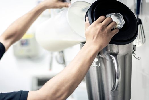 making gelato ice cream with modern professional equipment preparation detail in kitchen interior